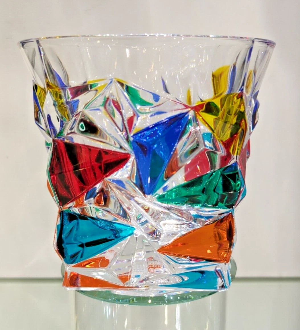 A multicolored geometric patterned whiskey glass.
