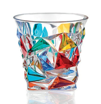 A multicolored geometric patterned whiskey glass with a clear central section and colorful accents.
