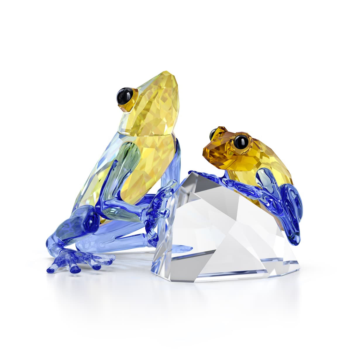 Glass frog figurines on a crystal base against a white background