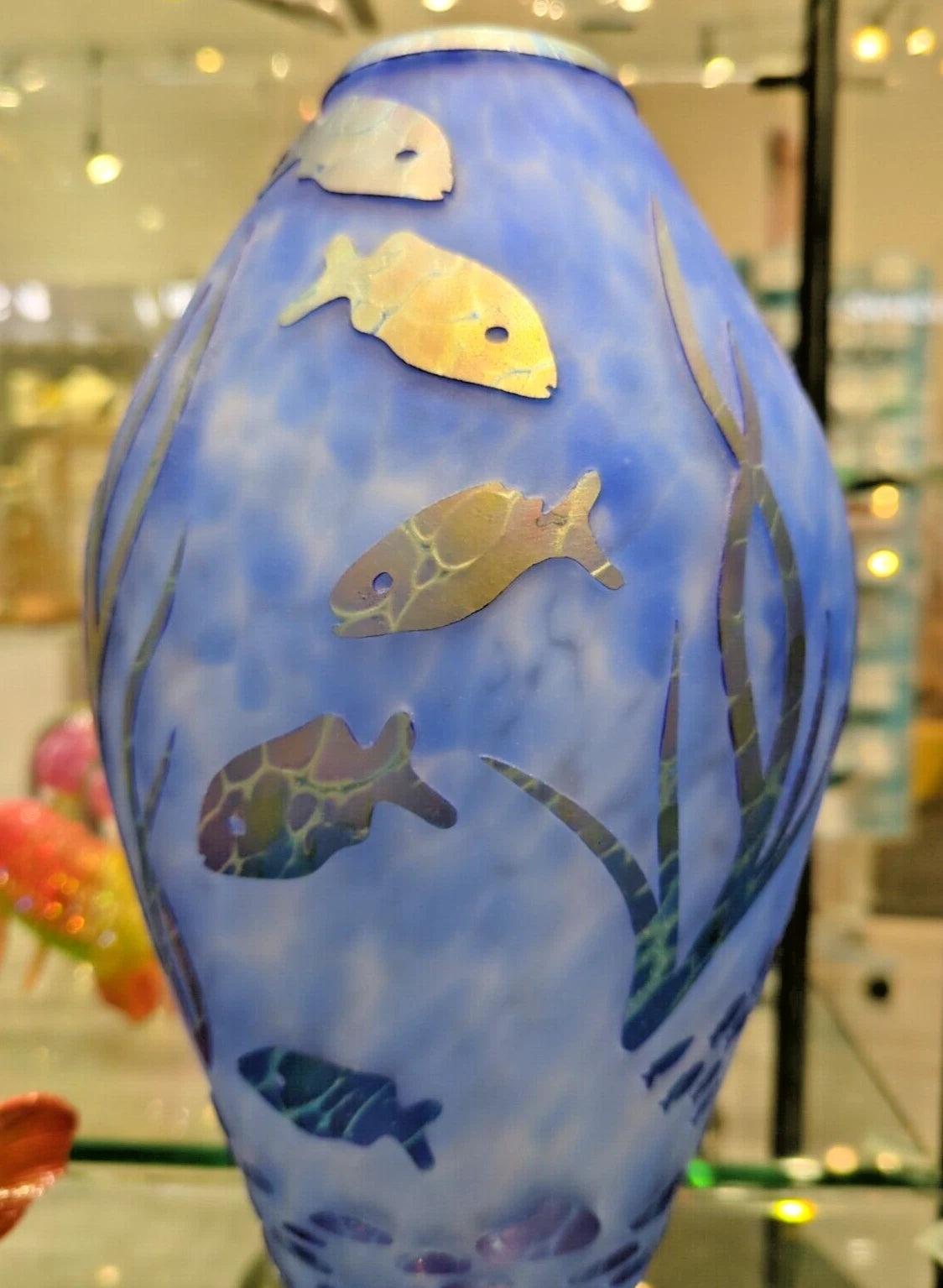 Decorative vase with fish and underwater scene design on a blue background