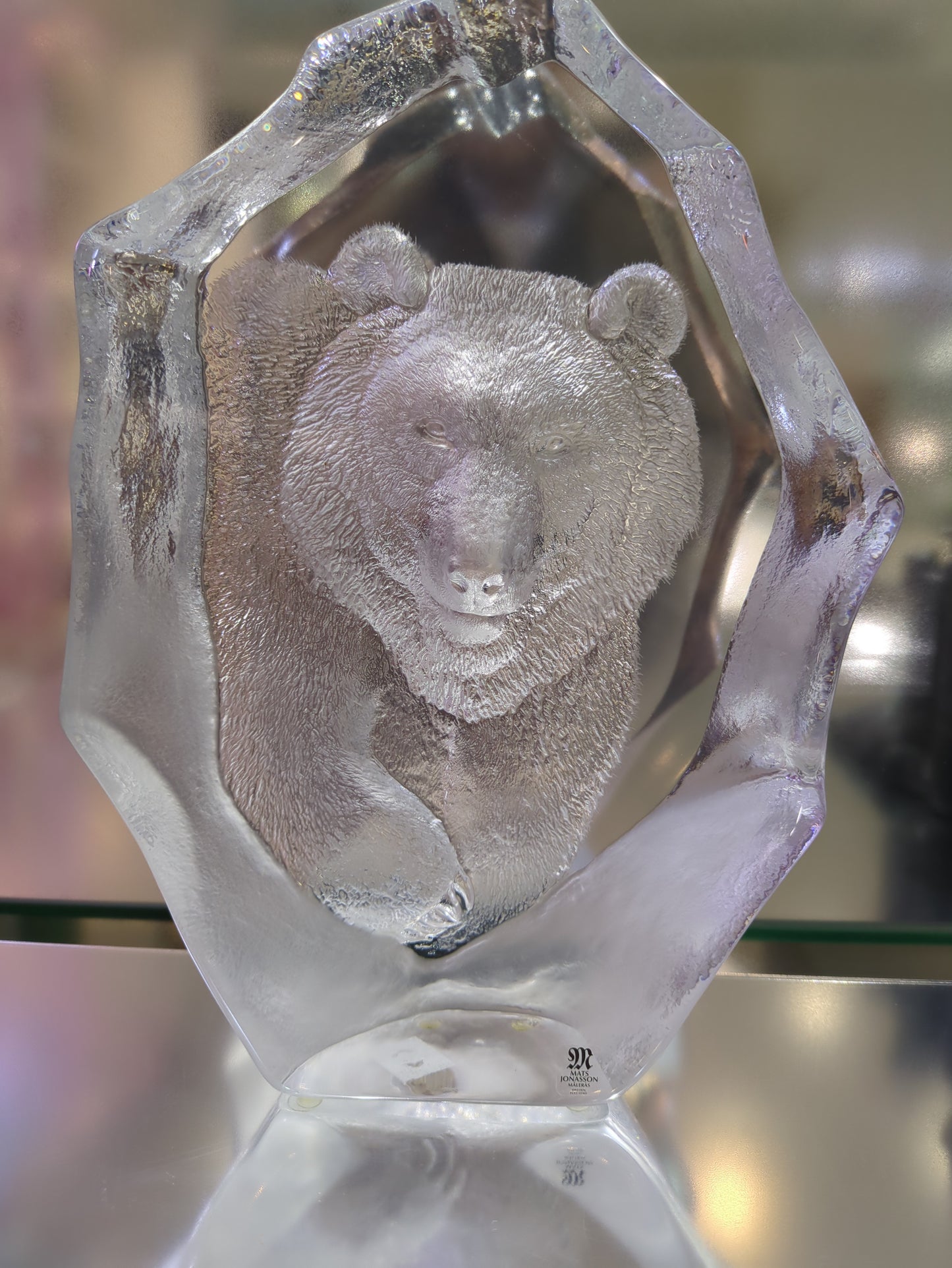 Close-up of a crystal with an embedded stone on a blurred background