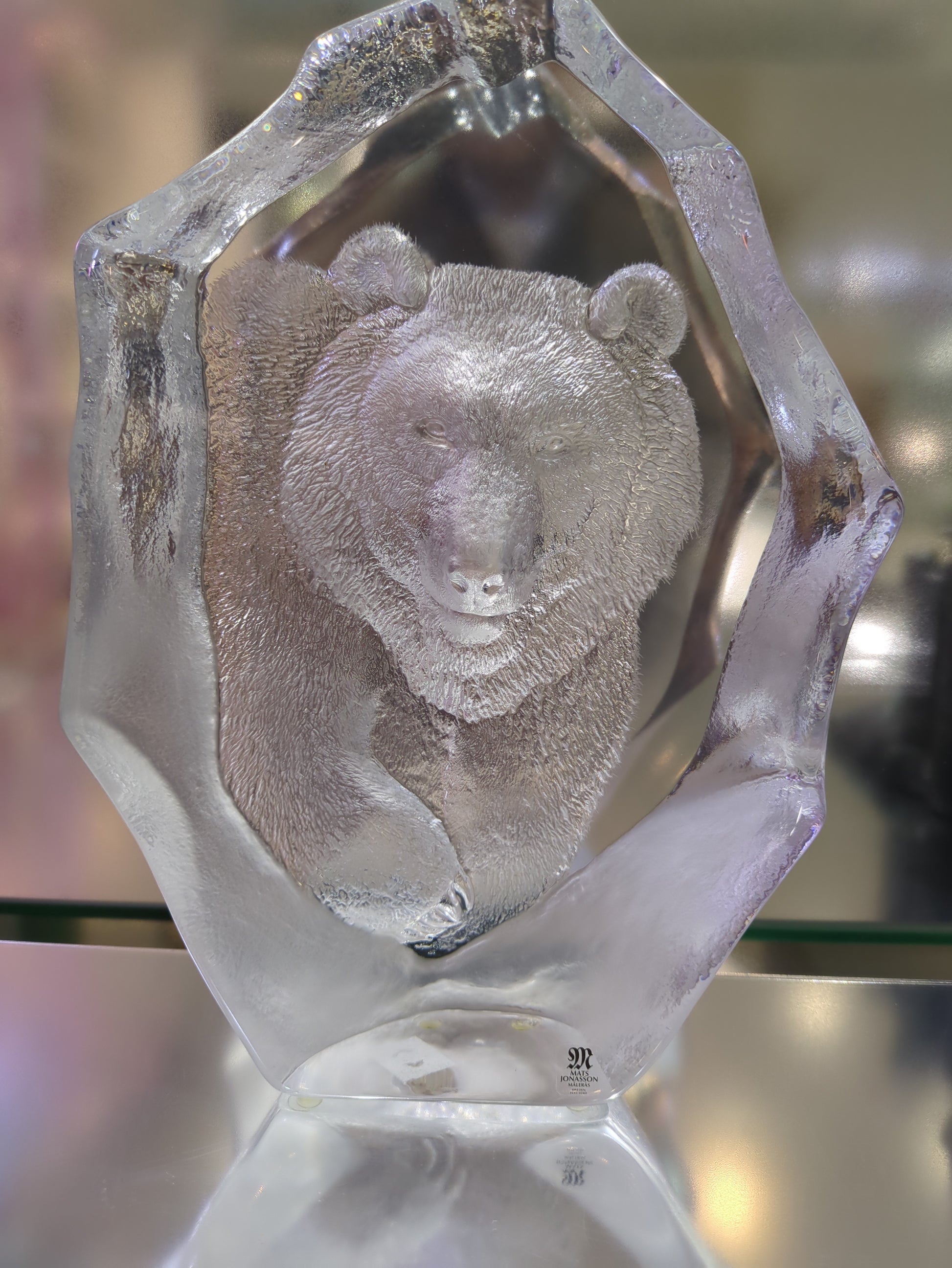Close-up of a crystal with an embedded stone on a blurred background