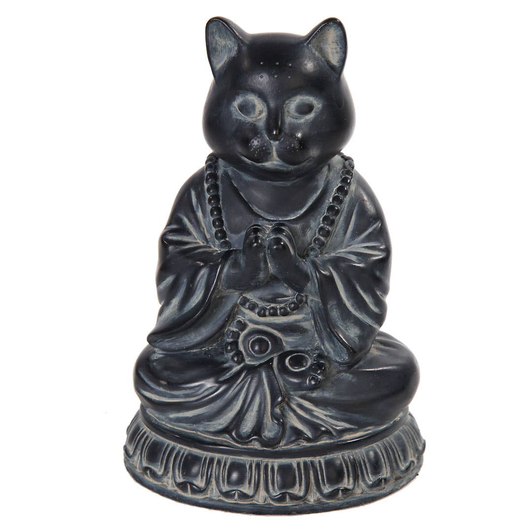 Black cat figurine in a meditative pose on a white background