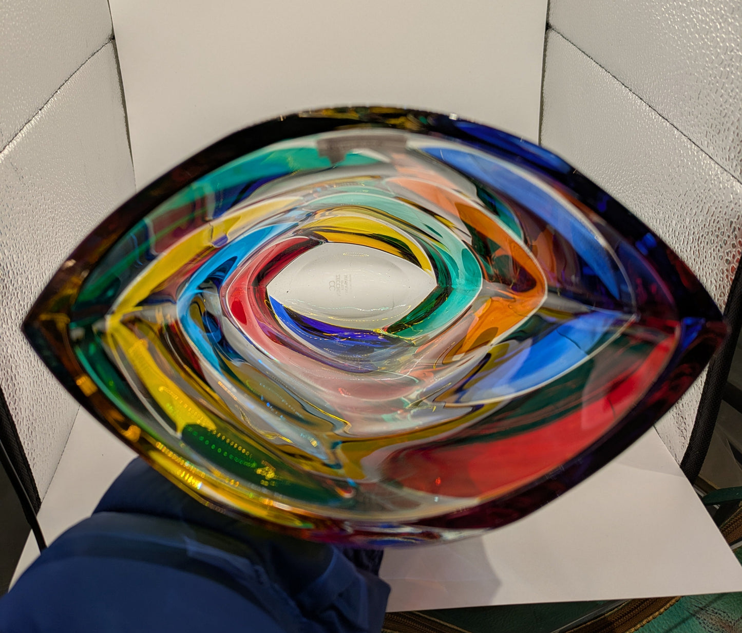 A multicolored, geometric patterned Murano glass vase displayed against a white background.