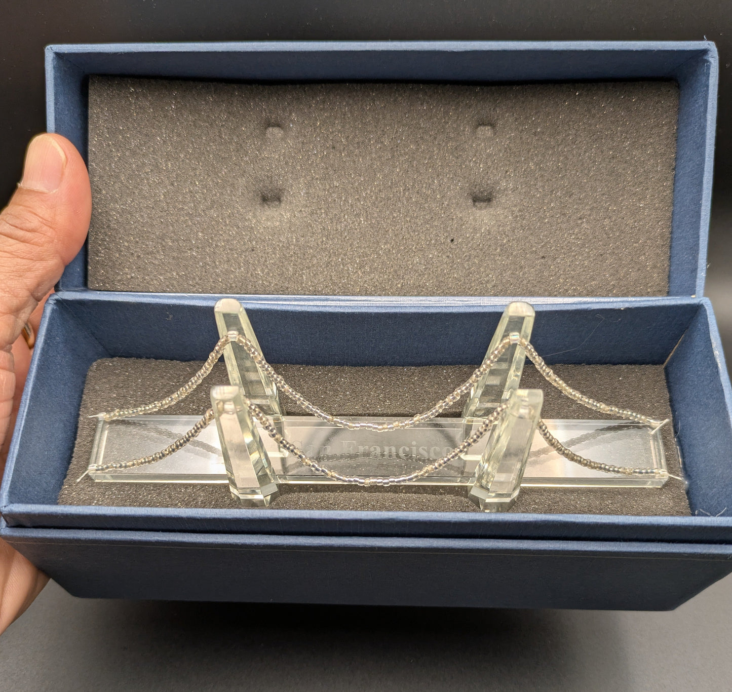 Clear glass bridge model in a blue box