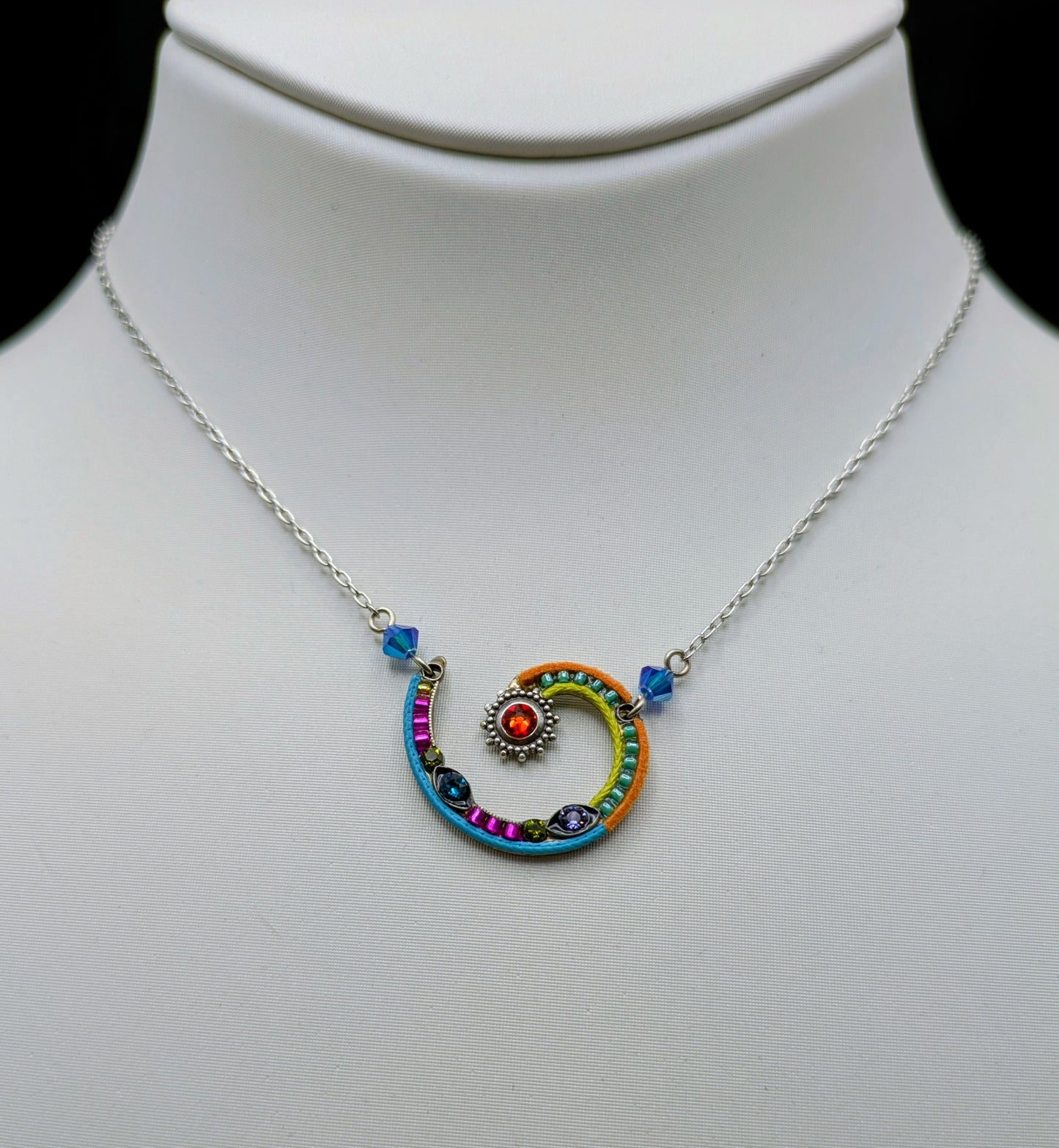 Colorful spiral pendant necklace on a mannequin neck
