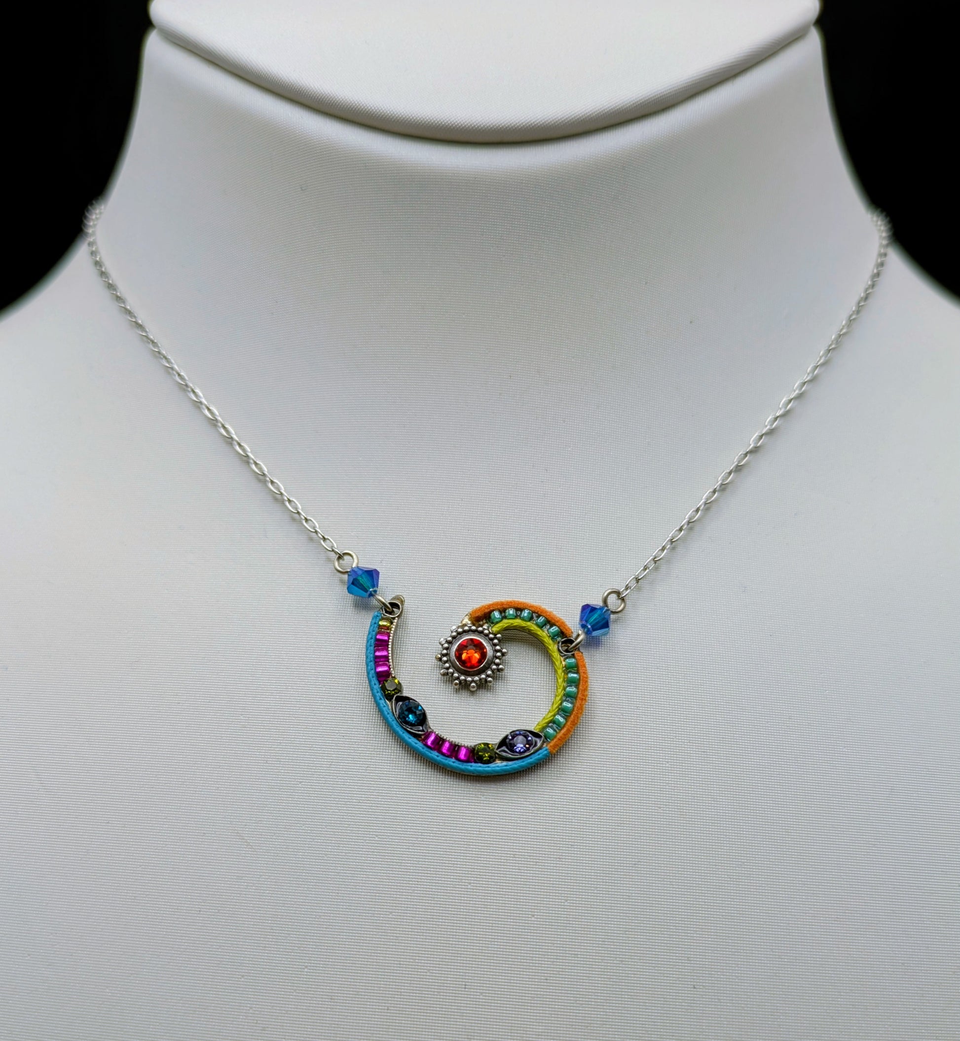 Colorful spiral pendant necklace on a mannequin neck