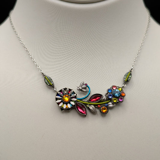 Colorful floral necklace on a mannequin with a plain background