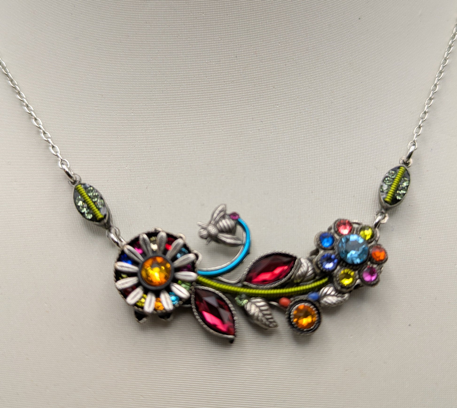 Necklace with colorful floral design on a mannequin