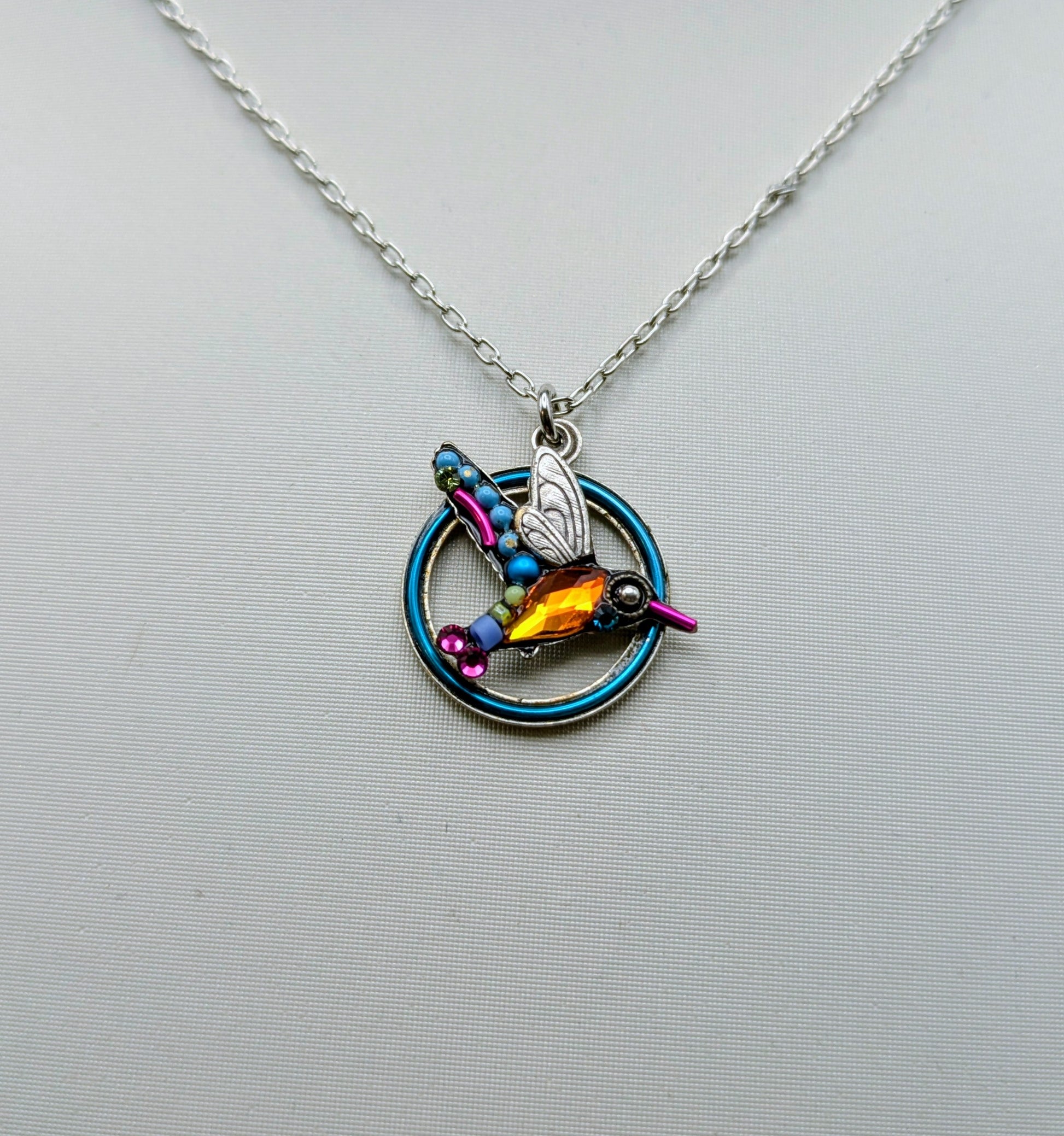 Necklace with a colorful pendant on a mannequin