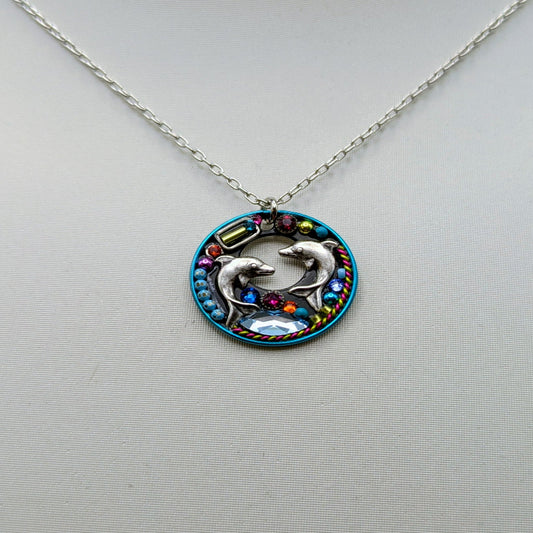 Necklace with a pendant featuring a dolphin design on a mannequin.