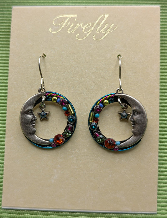 Pair of earrings on a 'Firefly' branded card with a green background