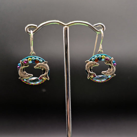 Pair of earrings on a stand with a dark background