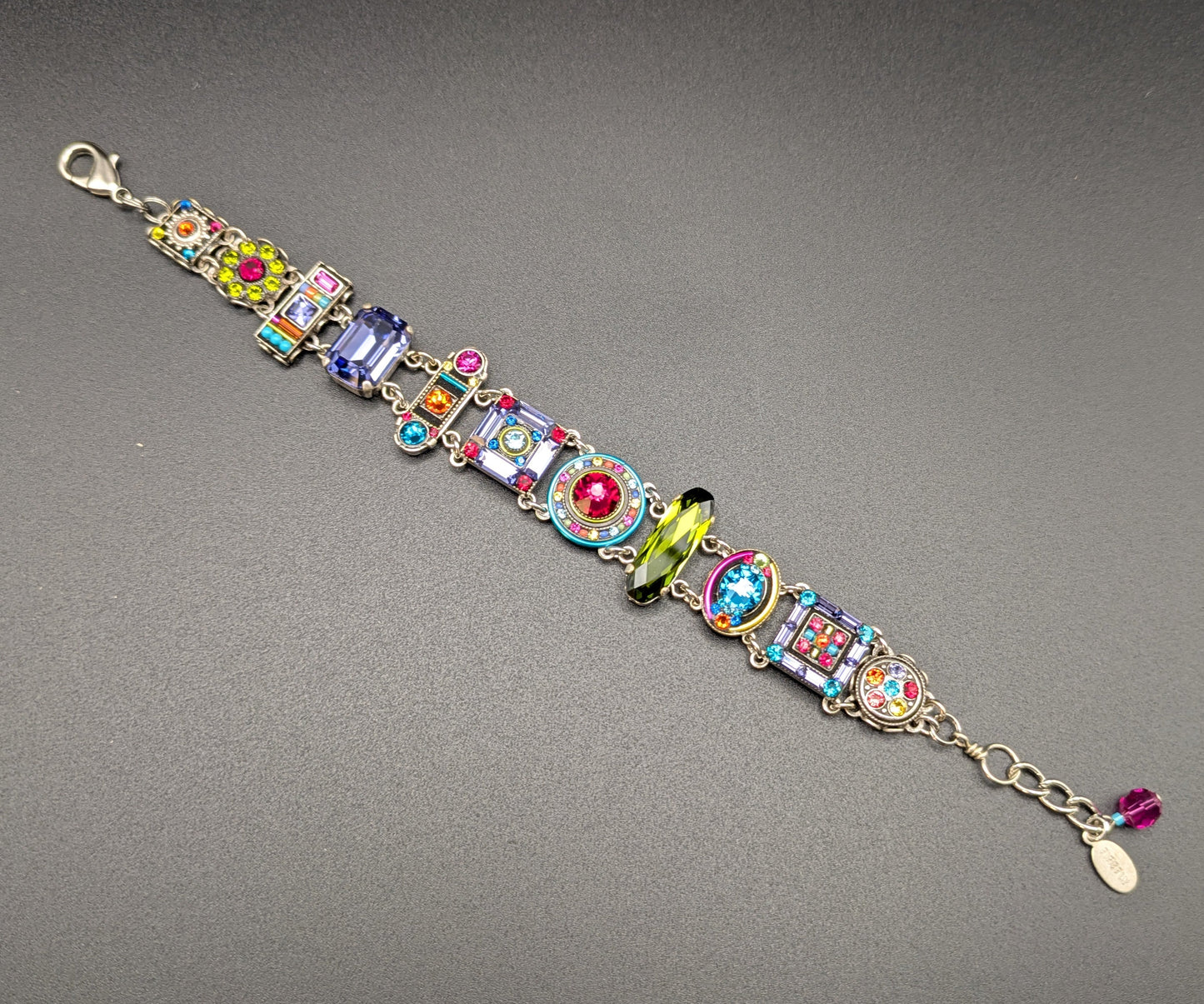 Multicolored beaded bracelet on a gray background