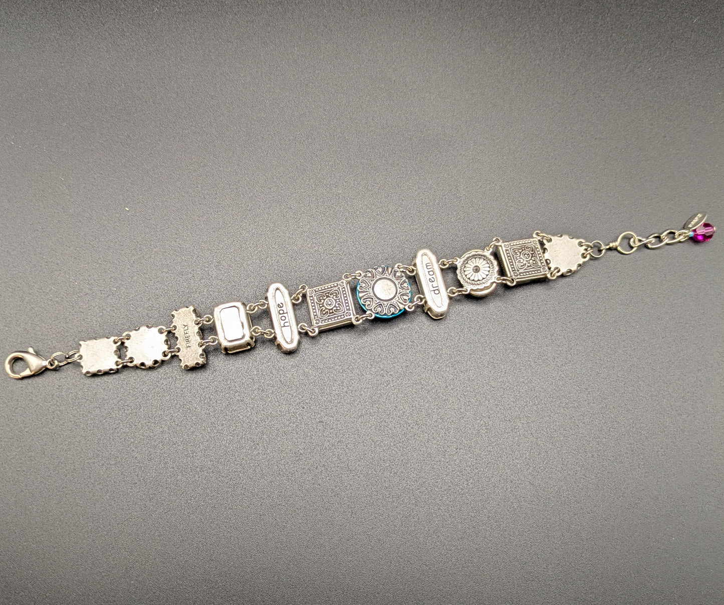 Bracelet with gemstones back view on a gray background