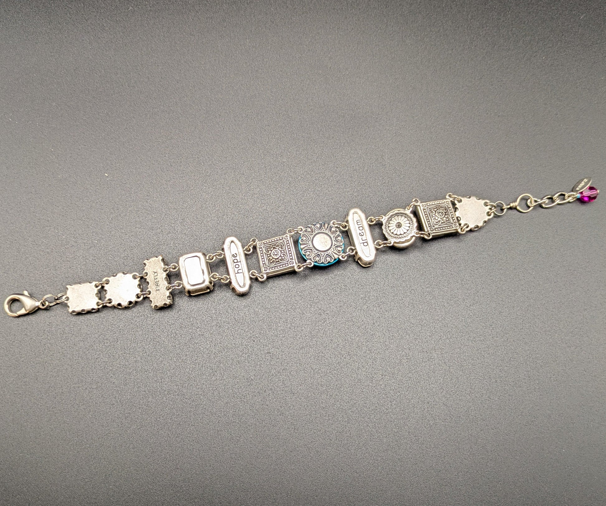 Bracelet with gemstones back view on a gray background