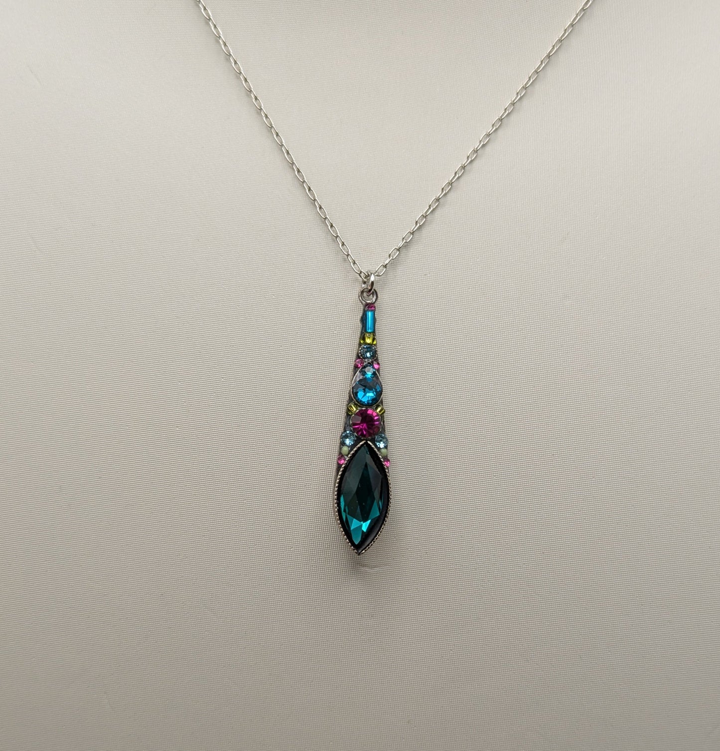 Necklace with a teardrop-shaped pendant on a mannequin bust.