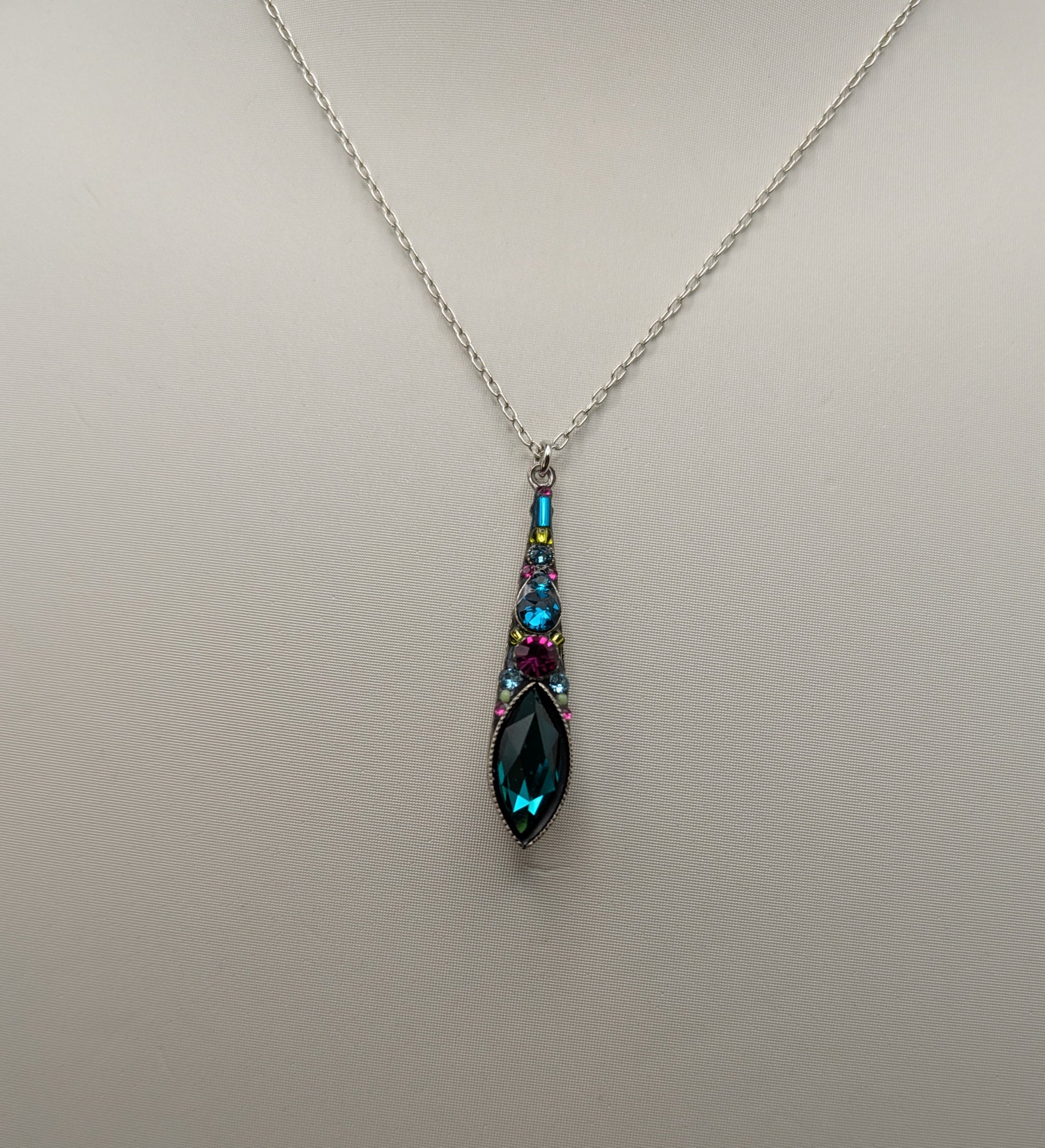 Necklace with a teardrop-shaped pendant on a light gray background