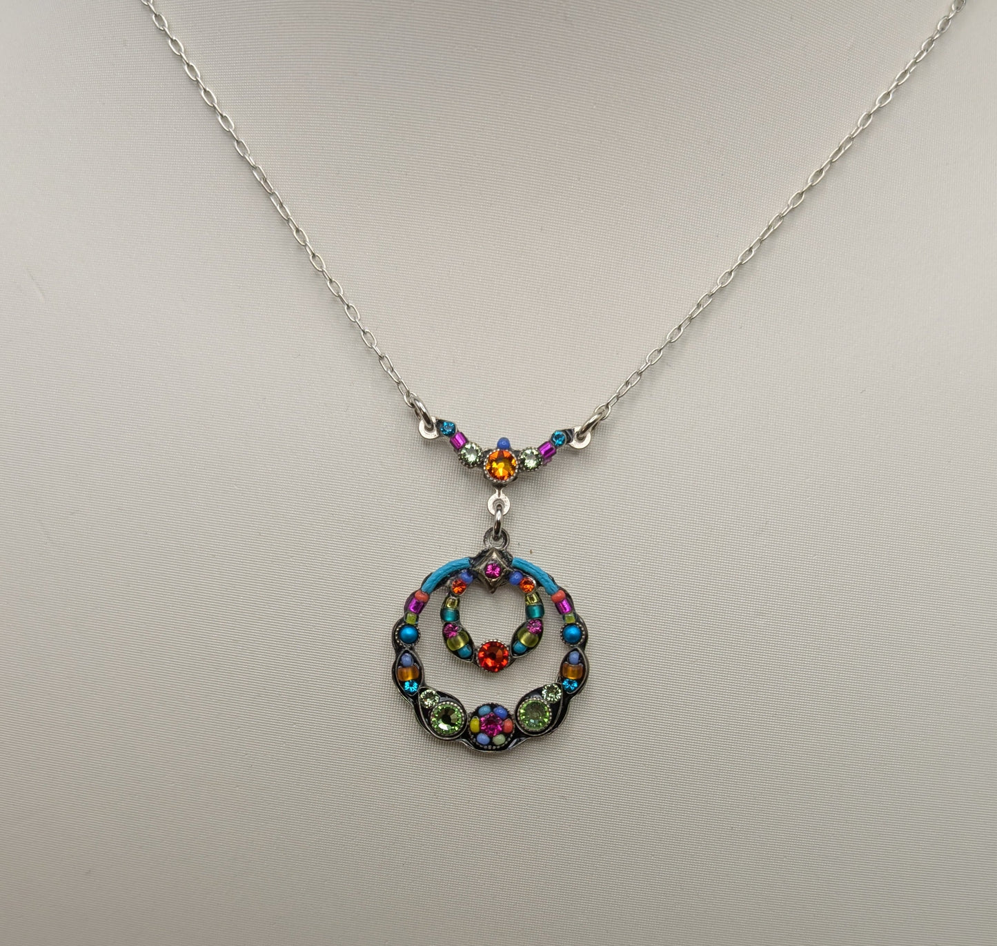 Necklace with a colorful pendant on a mannequin