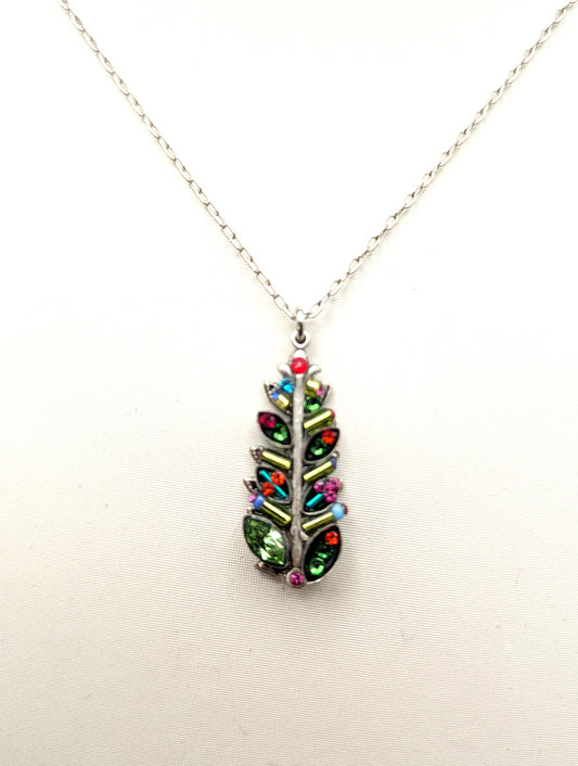 A silver chain necklace with a leaf-shaped pendant adorned with colorful rhinestones in green, red, pink, and blue, displayed against a plain white background.