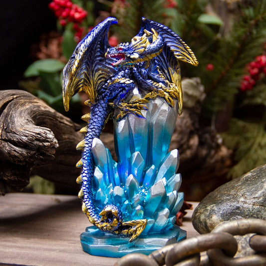 Decorative dragon figurine on a crystal base with a natural background