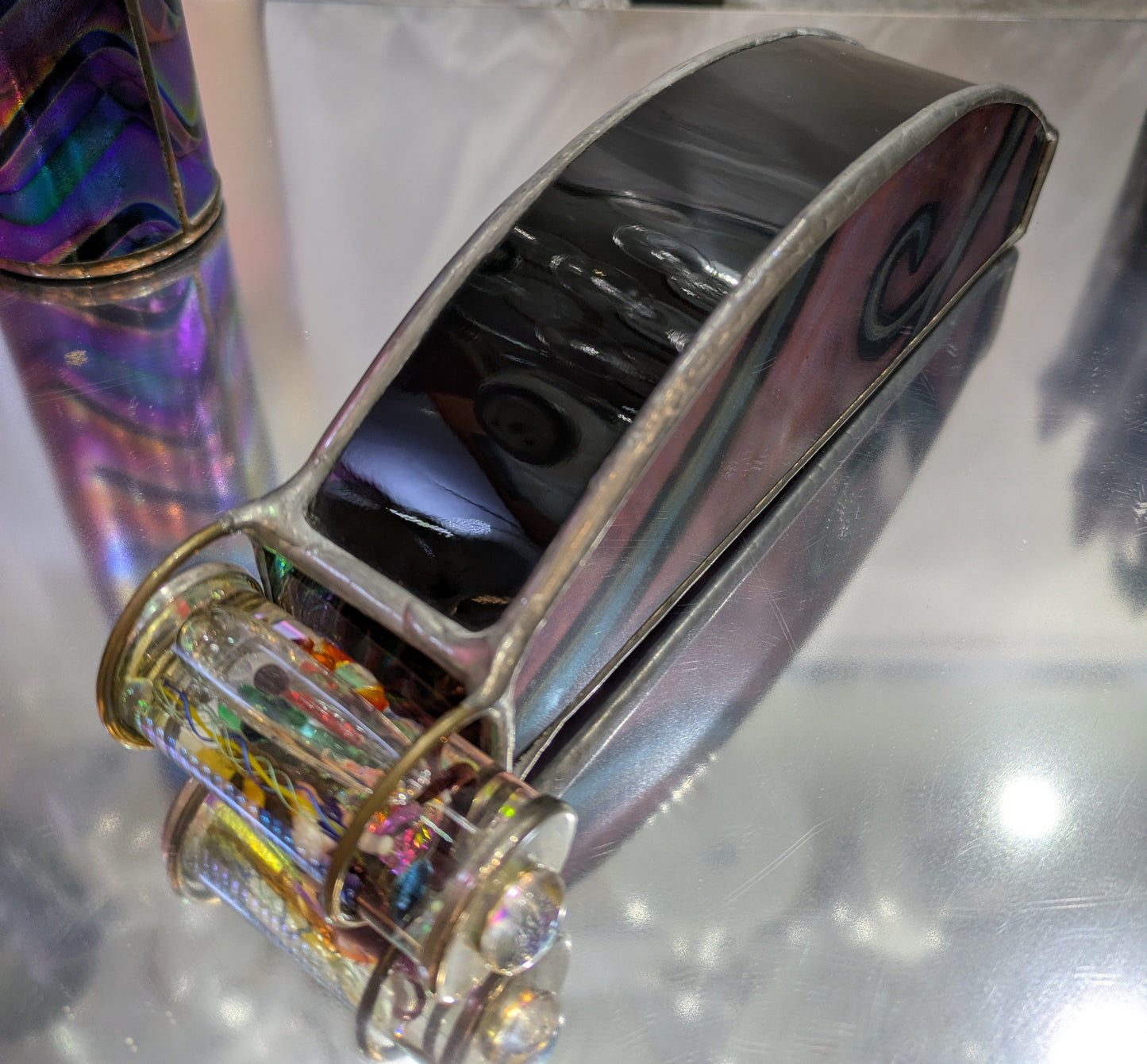 Metallic object with reflective surface on a reflective background