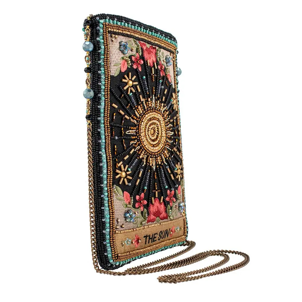 Beaded phone case with sun and floral designs on a white background