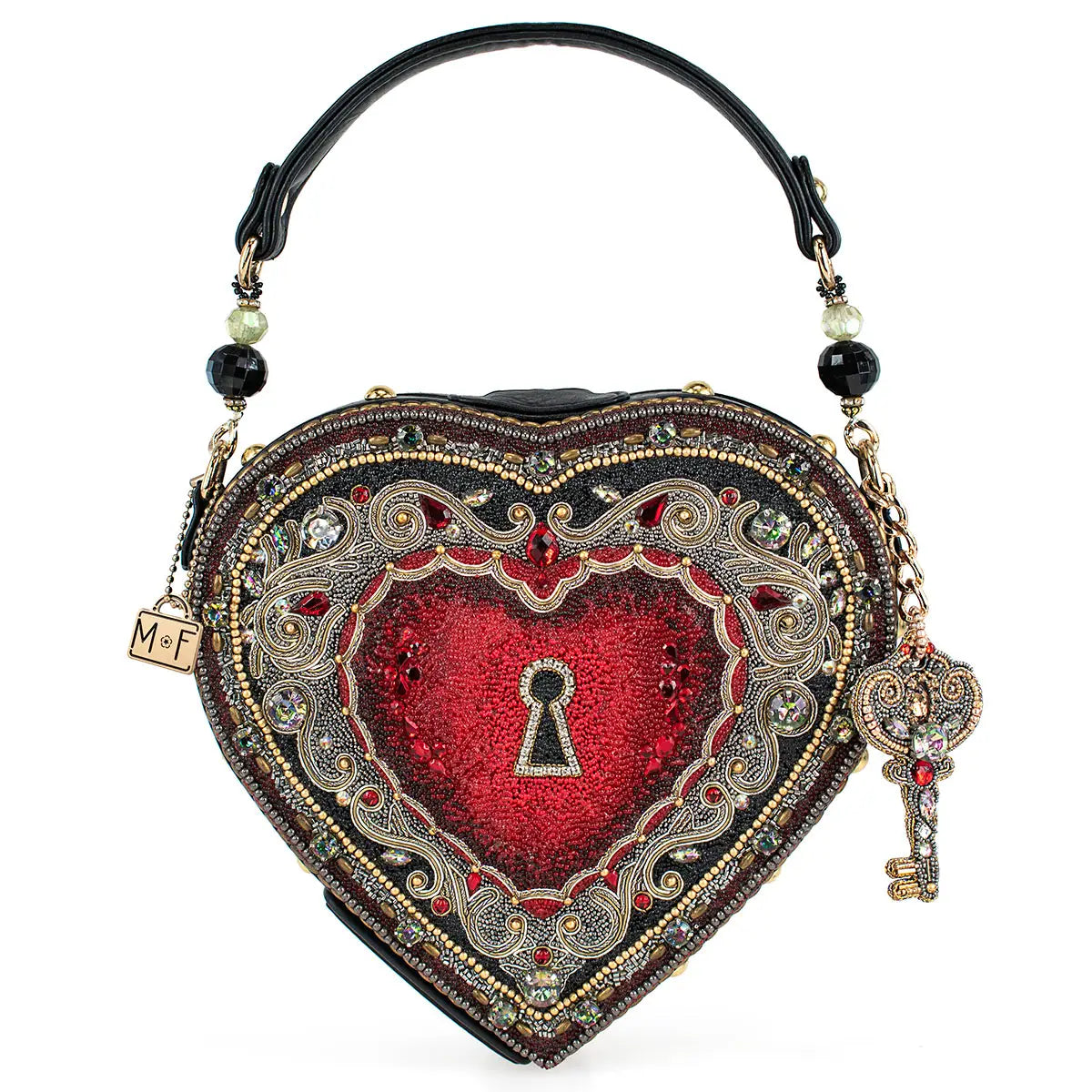 A heart-shaped red beaded handbag with intricate filigree design, a key hole top handle, and a removable key charm.