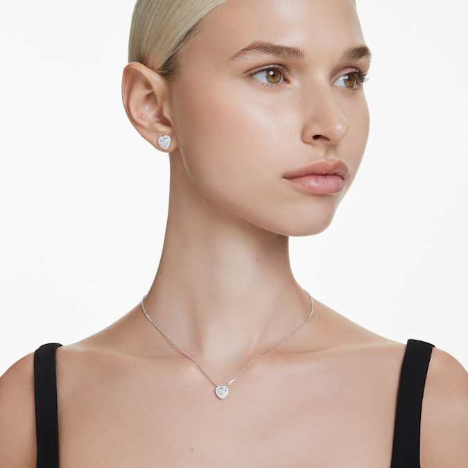 A model wearing a Swarovski heart necklace.