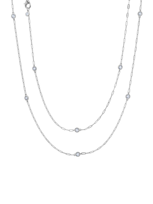 A platinum plated necklace with a paperclip chain and bezel-set cubic zirconia studs, displayed against a white background.