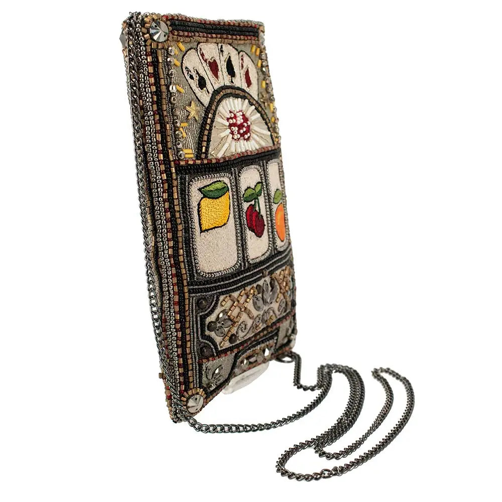 A beaded crossbody phone bag designed to resemble a slot machine with various symbols, including cards and fruits, displayed on the front.