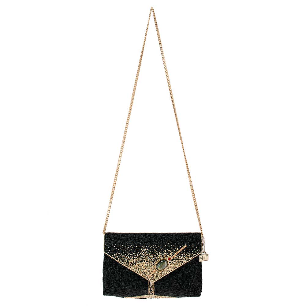 Black clutch bag with gold chain strap on a white background