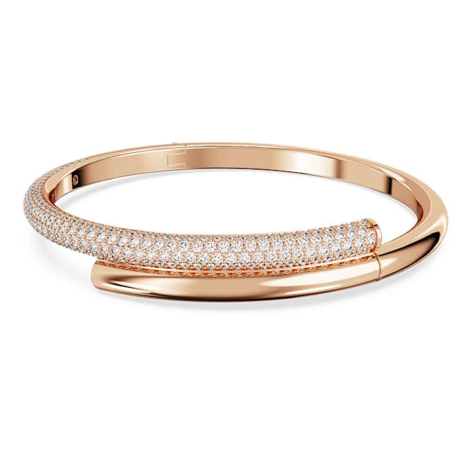 A rose gold-tone plated bangle bracelet with a clear pavé embellishment and a magnetic closure.