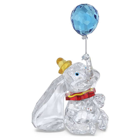 A crystal figurine of Disney's Dumbo with a blue balloon and multicolored circus outfit.