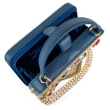 Blue handbag with gold chain and embellishments on a white background