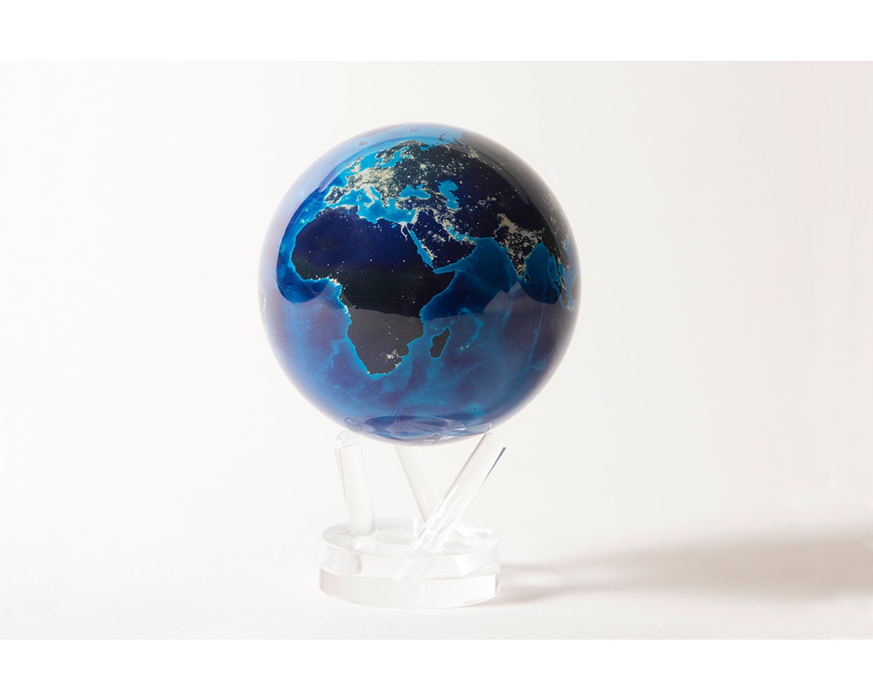 A 4.5 inch MOVA globe depicting the Earth at night, with illuminated city lights against a dark landmass, placed on a clear stand.