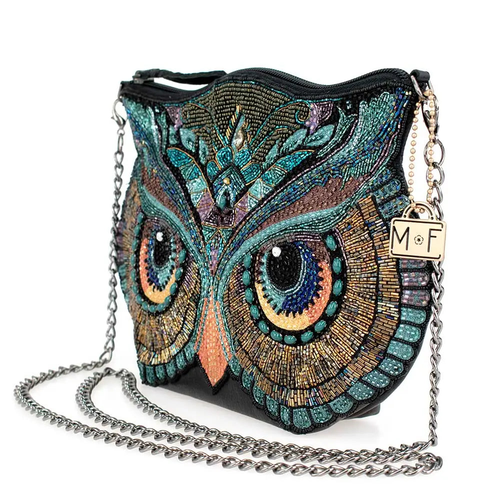 Beaded owl-shaped handbag with chain strap on a white background