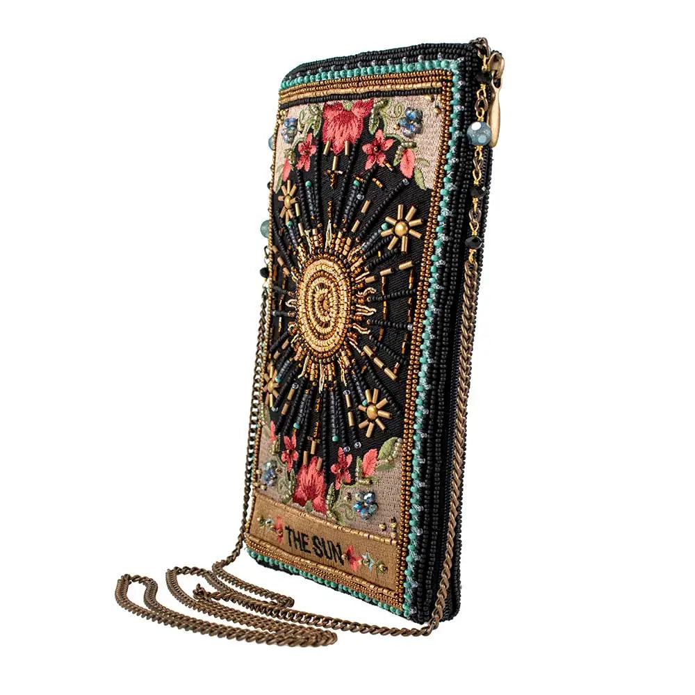 Beaded handbag with floral and celestial designs on a white background