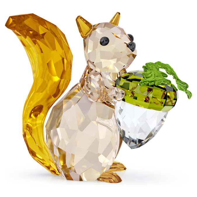 A figurine of a squirrel holding an acorn, crafted from multicolored crystals and lacquered metal.