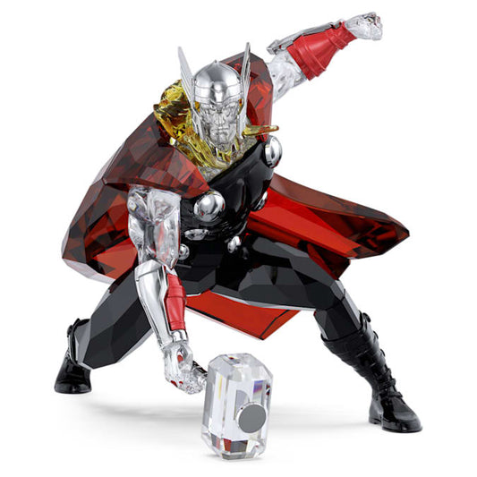 A crystal figurine of Marvel's Thor in a dynamic pose with a red and silver costume, holding a hammer, displayed with a small crystal ornament.