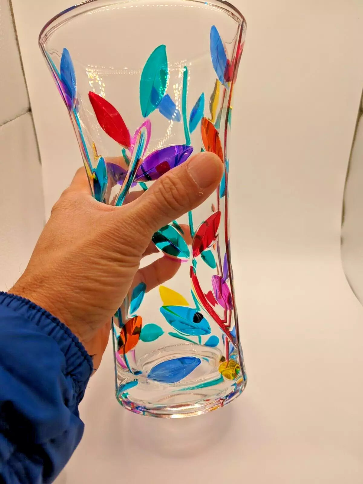 Vase is on hand with different view.