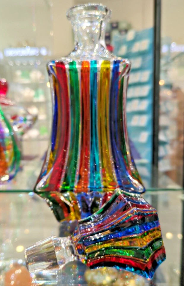 Murano decanter with glass lid on the side.