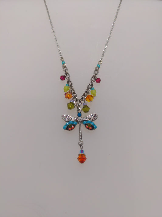 A multicolored Firefly brand necklace featuring a dragonfly design with intricate embellishments and a chain link.