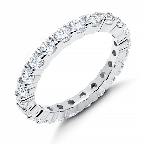 A round-cut eternity band ring with cubic zirconia stones, finished in pure platinum, displayed against a white background.