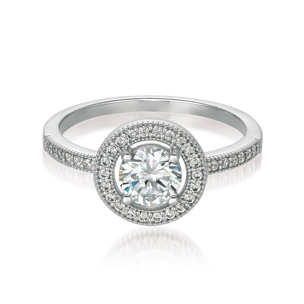 A brilliant halo ring finished in pure platinum, featuring a round centerpiece stone with Cubic Zirconia, surrounded by a halo of smaller stones, set in a silver band.