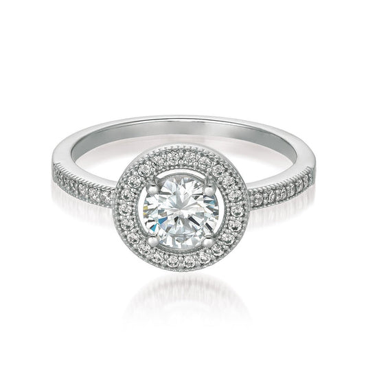 A brilliant halo ring finished in pure platinum, featuring a round centerpiece stone with Cubic Zirconia, surrounded by a halo of smaller stones, set in a silver band.