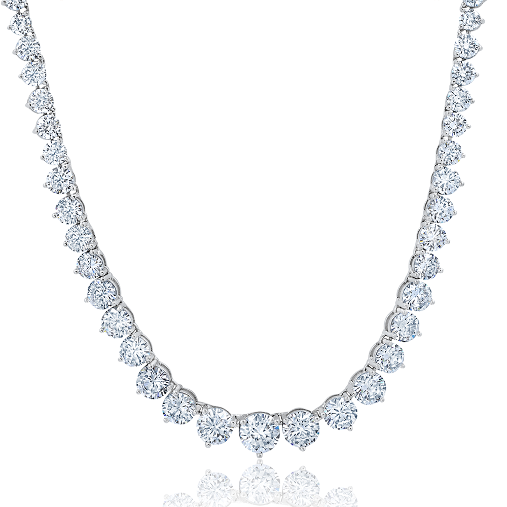 A graduated tennis necklace crafted in silver and finished in pure platinum with sparkling stones.