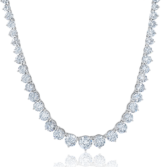 A graduated tennis necklace crafted in silver and finished in pure platinum with sparkling stones.