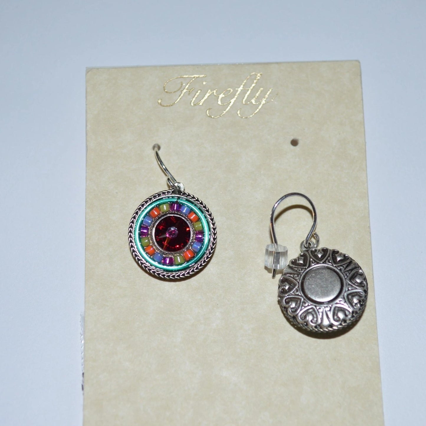 A pair of multi color Firefly Jewelry earrings on white background