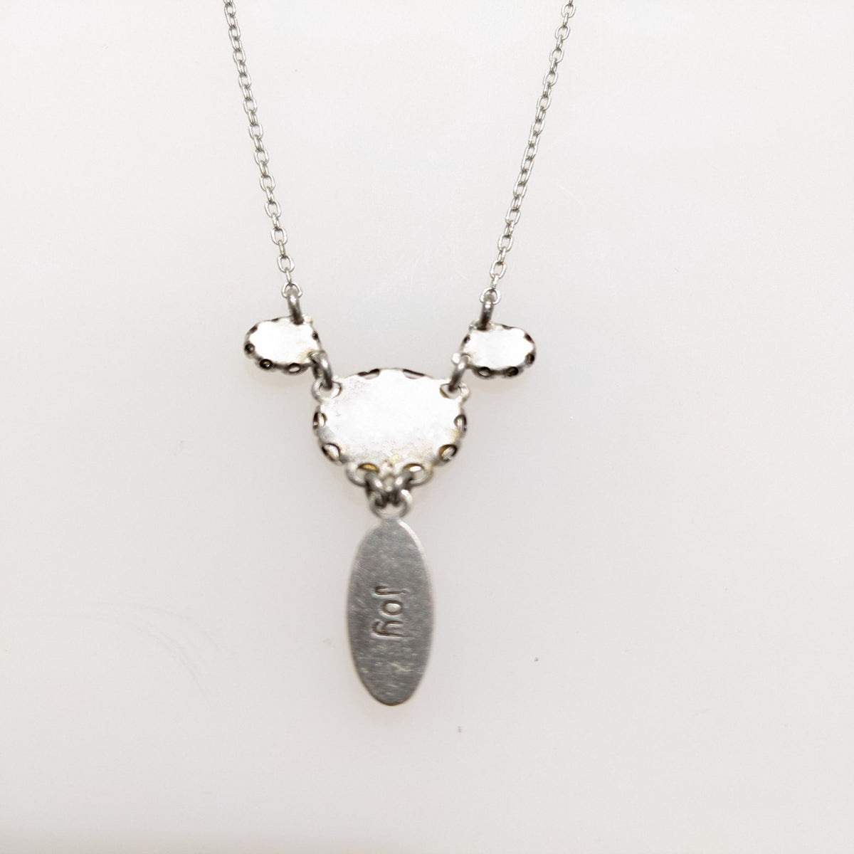 Necklace with back view on white background.